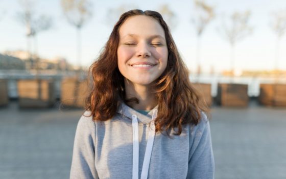 Canva-Portrait-of-a-Happy-Teen-Girl-with-Eyes-Closed-Golden-Hour.